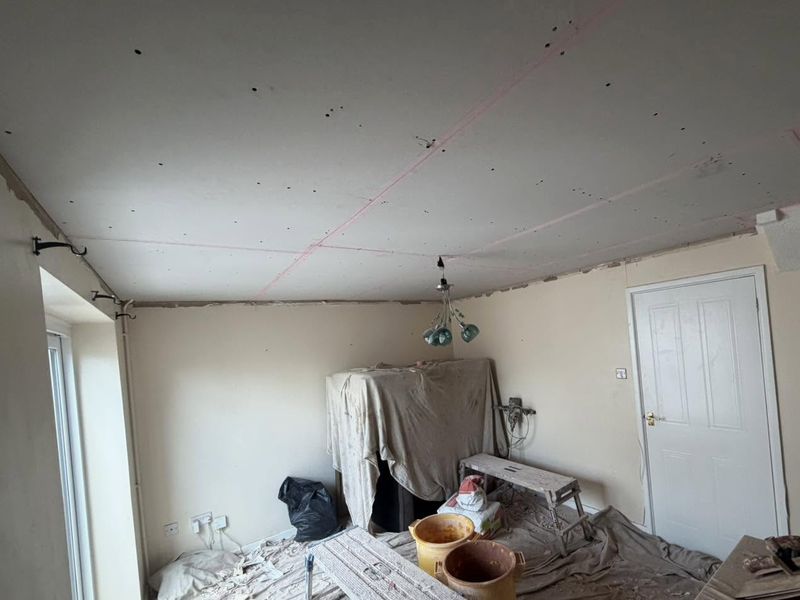 The living room from the other side, ceiling boarded and taped