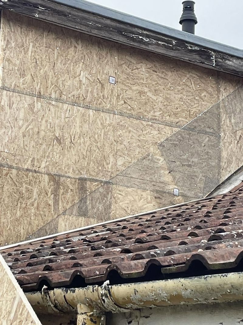The dormer cheek covered in new boards, with mesh over the joints